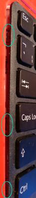 Picture of the clips at the left of the keyboard between Escape and backtick, near Caps Lock and near Ctrl