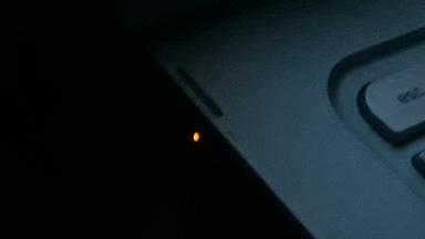 Picture of a solid orange light next to the charger