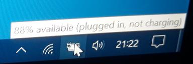 Windows battery icon with mouseover text “88% available (plugged in, not charging)”.